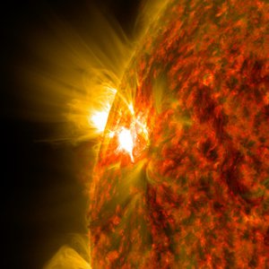 An image of the Sun in extreme ultraviolet light. A flare is distinctly visible.