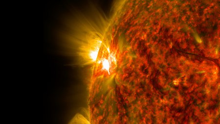 An image of the Sun in extreme ultraviolet light. A flare is distinctly visible.