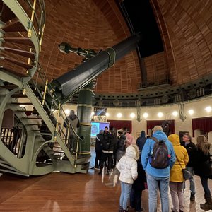 People in a dome next to a telescope