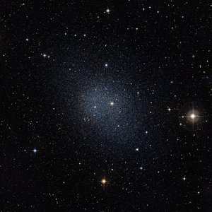 Dark sky with a brighter spot in the centre, which consists of many stars