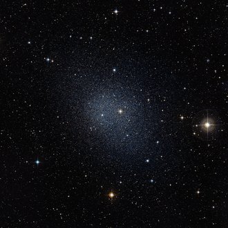 Dark sky with a brighter spot in the centre, which consists of many stars