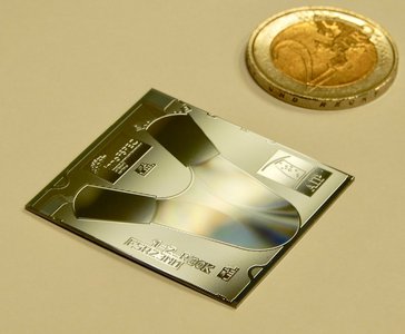 Electronic chip next to a 2-Euro coin for size comparison