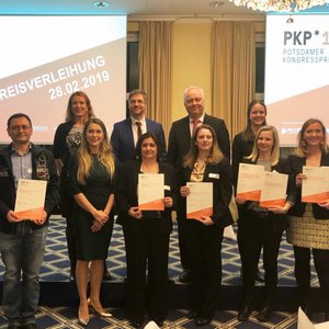 Group photo of the winners holding their certificates with the Mayor of Potsdam and staff of the Congress Award.