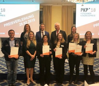 Group photo of the winners holding their certificates with the Mayor of Potsdam and staff of the Congress Award.