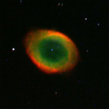 Foto eines ringförmigen Nebels mit grünem Zentrum und rotem äußeren Ring