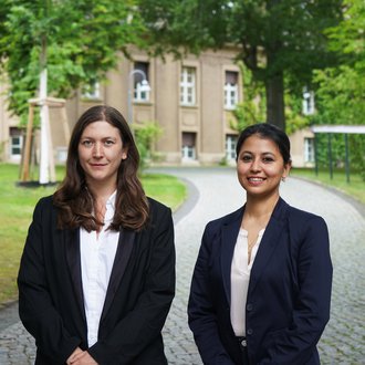 Two women in a park-like area